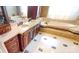 Luxurious main bathroom featuring a double vanity, soaking tub, and marble flooring at 708 Ridgelake Dr, Weddington, NC 28104