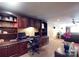 Office with wood cabinets and desk, monitors, and black chair at 708 Ridgelake Dr, Weddington, NC 28104