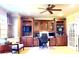 Well-appointed home office with custom built-ins, ample desk space, and a ceiling fan at 708 Ridgelake Dr, Weddington, NC 28104