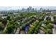 An aerial view of a neighborhood lined with green trees and a stunning city skyline with pin at 734 E 10Th St, Charlotte, NC 28202