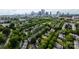 An aerial view of a neighborhood lined with green trees and a stunning city skyline at 734 E 10Th St, Charlotte, NC 28202