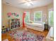 Bright bedroom with a daybed, colorful rug, and a house-shaped bookcase at 734 E 10Th St, Charlotte, NC 28202