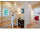 Entryway with wooden stairs, hardwood floors, side table, and decorative wall clock at 734 E 10Th St, Charlotte, NC 28202