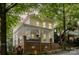 Attractive two-story home featuring a spacious front porch with white railings and a brick foundation at 734 E 10Th St, Charlotte, NC 28202