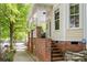 Side view of a two-story house with a brick foundation and steps leading to a side entrance at 734 E 10Th St, Charlotte, NC 28202