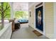 Inviting front porch with ample seating, ceiling fan, and a charming blue front door at 734 E 10Th St, Charlotte, NC 28202
