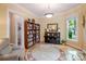 Bright living room with piano, bookshelf, and area rug at 734 E 10Th St, Charlotte, NC 28202