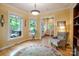 Bright living room with a comfortable chair, large windows, and decorative rug at 734 E 10Th St, Charlotte, NC 28202