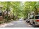 Picturesque neighborhood street lined with mature trees and parked cars, perfect for a leisurely stroll at 734 E 10Th St, Charlotte, NC 28202
