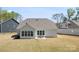 Aerial view of home and yard showing patio, home's roof, siding, and the grassy backyard at 7500 Happy Hollow Dr, Mint Hill, NC 28227