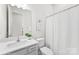 Well-lit bathroom featuring a single sink vanity with a shower and tub at 7500 Happy Hollow Dr, Mint Hill, NC 28227