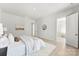 Bright bedroom with light wood floors, white walls, and neutral decor, with a view to the ensuite bathroom at 7500 Happy Hollow Dr, Mint Hill, NC 28227