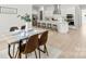 Dining area with a wood table, comfortable seating, and natural light next to the kitchen at 7500 Happy Hollow Dr, Mint Hill, NC 28227