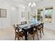 Bright dining room with a black table, chandelier and windows offering natural light at 7500 Happy Hollow Dr, Mint Hill, NC 28227