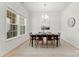 Bright dining room features modern chandelier and a window offering natural light at 7500 Happy Hollow Dr, Mint Hill, NC 28227