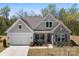 Beautiful home showcasing stone and shake accents, craftsman style details, well-manicured landscaping, and a two car garage at 7500 Happy Hollow Dr, Mint Hill, NC 28227