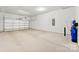 Spacious two car garage with high ceilings, concrete floors, and a water filtration system at 7500 Happy Hollow Dr, Mint Hill, NC 28227