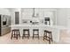 Bright kitchen features a large island, stainless steel appliances, and stylish bar stool seating at 7500 Happy Hollow Dr, Mint Hill, NC 28227