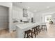 This bright kitchen features an island with barstool seating and modern appliances at 7500 Happy Hollow Dr, Mint Hill, NC 28227