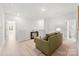 Relaxing living area featuring neutral colors, a sofa, and light wood floors for a soothing atmosphere at 7500 Happy Hollow Dr, Mint Hill, NC 28227