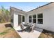 Back patio with furniture, siding, and sliding glass door to home's interior at 7500 Happy Hollow Dr, Mint Hill, NC 28227