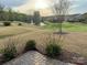 View of the lush backyard with a pond and fountain, offering a serene escape at 7581 Short Putt Ct, Charlotte, NC 28215