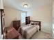 Cozy bedroom showcases a comfortable bed, matching wood furniture, and a window for natural light at 7581 Short Putt Ct, Charlotte, NC 28215