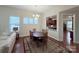 Open-concept dining area with hardwood floors, chandelier, and seamless access to the kitchen at 7581 Short Putt Ct, Charlotte, NC 28215