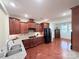 Modern kitchen boasts granite countertops, dark wood cabinets, and stainless steel appliances at 7581 Short Putt Ct, Charlotte, NC 28215