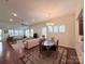 Open living and dining room with hardwood floors and abundant natural light at 7581 Short Putt Ct, Charlotte, NC 28215