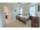 Comfortable main bedroom with tray ceiling, neutral color scheme, and en-suite bathroom at 7581 Short Putt Ct, Charlotte, NC 28215