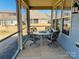 Enclosed patio featuring a glass table and seating for four, perfect for outdoor dining at 7581 Short Putt Ct, Charlotte, NC 28215