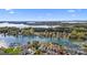 Stunning aerial view of waterfront condos with lake access, boat slips, and manicured lawns under a clear blue sky at 7844 Village Harbor Dr, Cornelius, NC 28031
