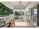 Cozy outdoor balcony featuring a wooden deck, white railing, and comfortable seating arrangement with lake views at 7844 Village Harbor Dr, Cornelius, NC 28031