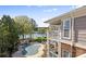 Exterior view of a condo building overlooking a pool, lake view, and private balcony with a covered porch at 7844 Village Harbor Dr, Cornelius, NC 28031