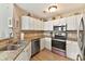 Well-lit kitchen featuring stainless steel appliances, granite countertops, and ample white cabinetry at 7844 Village Harbor Dr, Cornelius, NC 28031