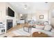 Spacious living room with fireplace, comfortable seating, wood floors, and an open floor plan flowing into the kitchen at 7844 Village Harbor Dr, Cornelius, NC 28031