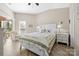Spacious main bedroom with a ceiling fan, light-colored walls, and sliding glass door to a balcony at 7844 Village Harbor Dr, Cornelius, NC 28031