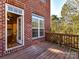 View from back porch through open doorway to living area with beautiful yard and natural light at 7854 Springs Village Ln, Charlotte, NC 28226