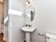 Cozy half bathroom features a pedestal sink and neutral wall colors at 7854 Springs Village Ln, Charlotte, NC 28226
