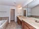 Bathroom featuring double vanity, tub, and tiled shower at 7854 Springs Village Ln, Charlotte, NC 28226