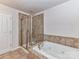 Bathroom featuring a tiled shower and a tub at 7854 Springs Village Ln, Charlotte, NC 28226