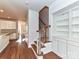 Inviting entryway featuring hardwood floors, staircase, and built-in shelving, blending functionality with stylish design at 7854 Springs Village Ln, Charlotte, NC 28226