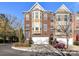 Brick townhouse with a two-car garage and well-maintained landscaping at 7854 Springs Village Ln, Charlotte, NC 28226