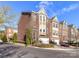 Exterior view of brick townhouses with manicured landscaping and attached garages at 7854 Springs Village Ln, Charlotte, NC 28226