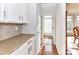 Hallway with granite countertops and leading to a brightly lit room at 7854 Springs Village Ln, Charlotte, NC 28226