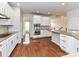 Spacious kitchen boasts stainless appliances, double ovens, and granite countertop island at 7854 Springs Village Ln, Charlotte, NC 28226