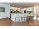 Well-lit kitchen with stainless appliances, granite counters, and bar stool seating at 7854 Springs Village Ln, Charlotte, NC 28226
