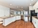 Bright kitchen featuring white cabinets, stainless appliances, and granite countertops at 7854 Springs Village Ln, Charlotte, NC 28226