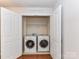 Convenient laundry closet with washer, dryer, and shelving for storage at 7854 Springs Village Ln, Charlotte, NC 28226